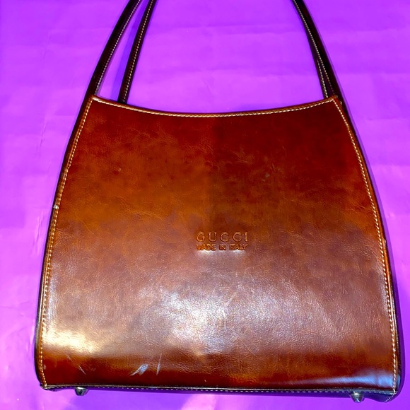 Vintage GUCCI leather bag from 1960. It has a boxy envelope style shape.
